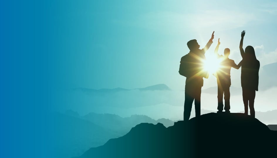 group standing on a hill high fiving